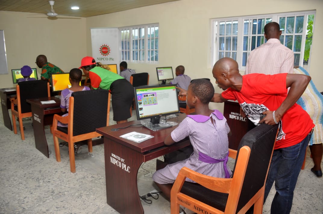 NIPCO staff assisting a student at the computer lab